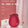 Wine red rose clitoral suction massager styled on a dressing table