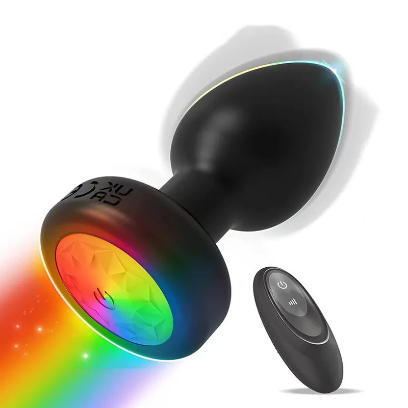 Quiet Control Massager - 1 Quiet Control remote control anal massager in black silicone with a rainbow LED base, shown with its wireless remote