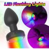 Lit base of the black anal massager cycling through its LED colour range
