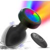 Black silicone anal massager with the LED base ring lit in rainbow colours